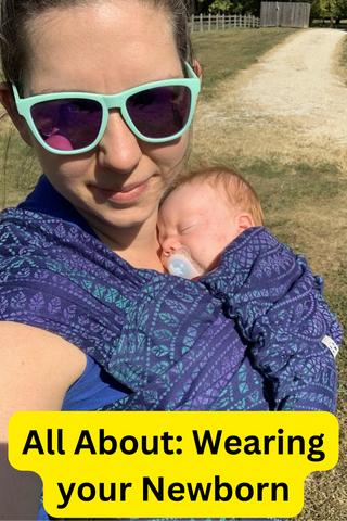 Mama & Roo's customer wearing her newborn in a Lenny Hybrid in print Peacock's Tail Provance