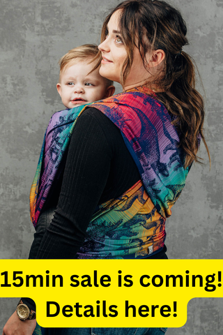 "15min sale is coming! Details here!" photo of mother wearing her toddler on her front in a long woven baby wrap in design Jurassic Park - New Era, available at mama-roo.com