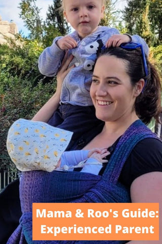 Mother carrying child in Sole Occidente wrap with another child on her shoulder. Text reads, "Mama & Roo's Guide: Experienced Parent"
