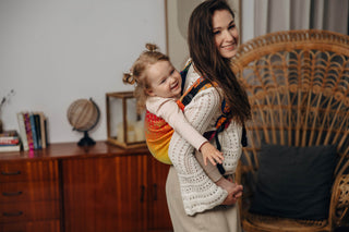 Preschool size wrap conversion waist-less onbuhimo baby backpack carrier for children from 3-7 years old in cotton woven design Rainbow Lotus, a jacquard weave with a bold rainbow gradient under an outlined repeating lotus flower pattern