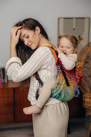 Preschool size wrap conversion waist-less onbuhimo baby backpack carrier for children from 3-7 years old in cotton woven design Rainbow Lotus, a jacquard weave with a bold rainbow gradient under an outlined repeating lotus flower pattern