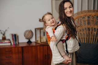 Preschool size wrap conversion waist-less onbuhimo baby backpack carrier for children from 3-7 years old in cotton woven design Rainbow Lotus, a jacquard weave with a bold rainbow gradient under an outlined repeating lotus flower pattern