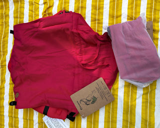 Preschool size wrap conversion waist-less onbuhimo baby backpack carrier for children from 3-7 years old in cotton woven design Sedona, a herringbone weave in red and orange. Shown next to a Toddler size onbuhimo pro in the same design