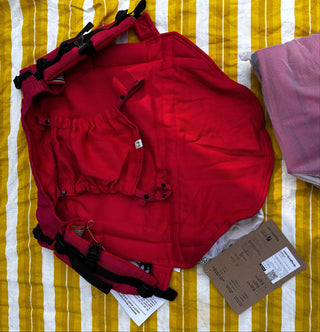 Preschool size wrap conversion waist-less onbuhimo baby backpack carrier for children from 3-7 years old in cotton woven design Sedona, a herringbone weave in red and orange. Shown next to a Toddler size onbuhimo pro in the same design