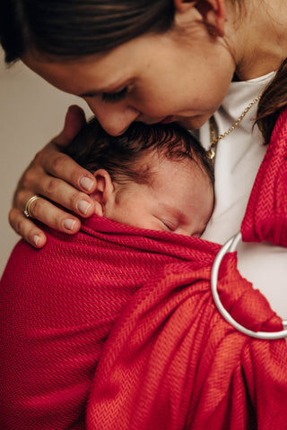 Wrap conversion ring sling baby carrier in cotton woven design Sedona, a red and orange herringbone weave