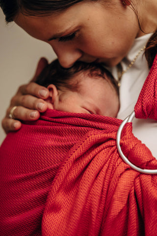 Wrap conversion ring sling baby carrier in cotton woven design Sedona, a red and orange herringbone weave