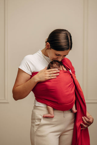 Wrap conversion ring sling baby carrier in cotton woven design Sedona, a red and orange herringbone weave
