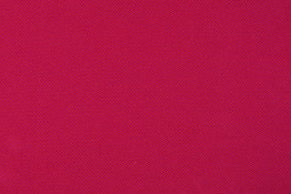 Flat lay of babywearing wrap fabric in cotton woven design Sedona, a beautiful rich red with hints of orange in a herringbone weave