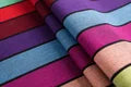 Lenny Lamb Long Woven Wrap - Carousel of Colors - Fabric close up. Wrap has horizontal stripes in rainbow colors with thin black stripes in-between the colors