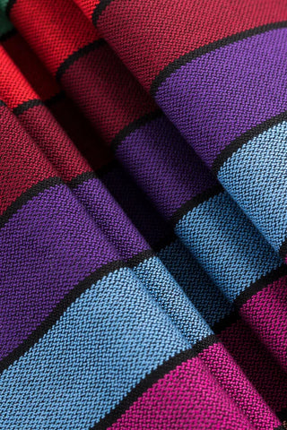 Lenny Lamb - Carousel of Colors - Fabric close up. Wrap has horizontal stripes in rainbow colors with thin black stripes in-between the colors