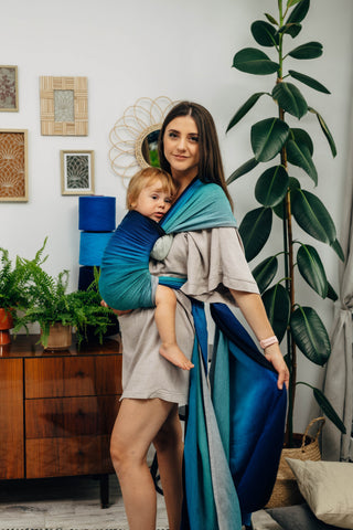 Long woven baby wrap baby carrier  in cotton woven design Airglow, a broken twill weave in an ombre gradient blue to turquoise to grey