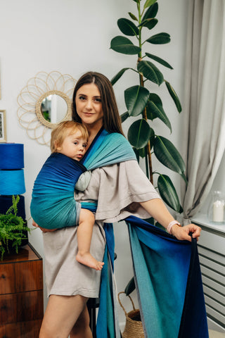 Long woven baby wrap baby carrier  in cotton woven design Airglow, a broken twill weave in an ombre gradient blue to turquoise to grey