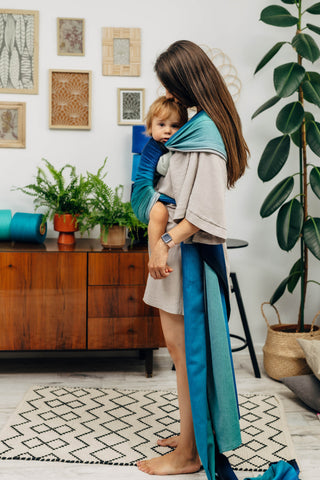 Long woven baby wrap baby carrier  in cotton woven design Airglow, a broken twill weave in an ombre gradient blue to turquoise to grey
