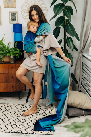 Long woven baby wrap baby carrier  in cotton woven design Airglow, a broken twill weave in an ombre gradient blue to turquoise to grey