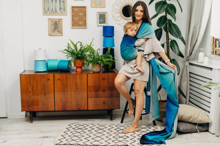 Long woven baby wrap baby carrier  in cotton woven design Airglow, a broken twill weave in an ombre gradient blue to turquoise to grey