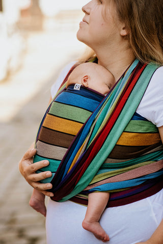 Lenny Lamb Long Woven Wrap - Carousel of Colors - newborn FWCC closeup. Wrap has horizontal stripes in rainbow colors with thin black stripes in-between the colors