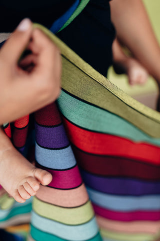 A close up of carousel of colors wrap, baby toes sneaking into the photo