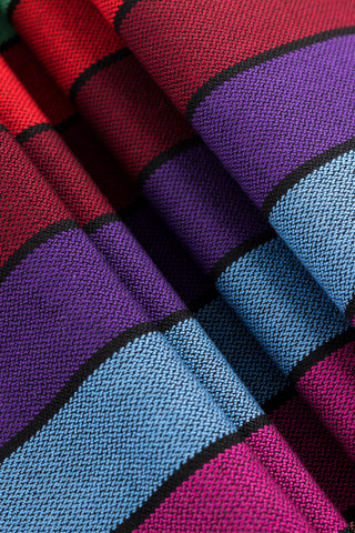 Lenny Lamb Long Woven Wrap - Carousel of Colors - Fabric close up. Wrap has horizontal stripes in rainbow colors with thin black stripes in-between the colors